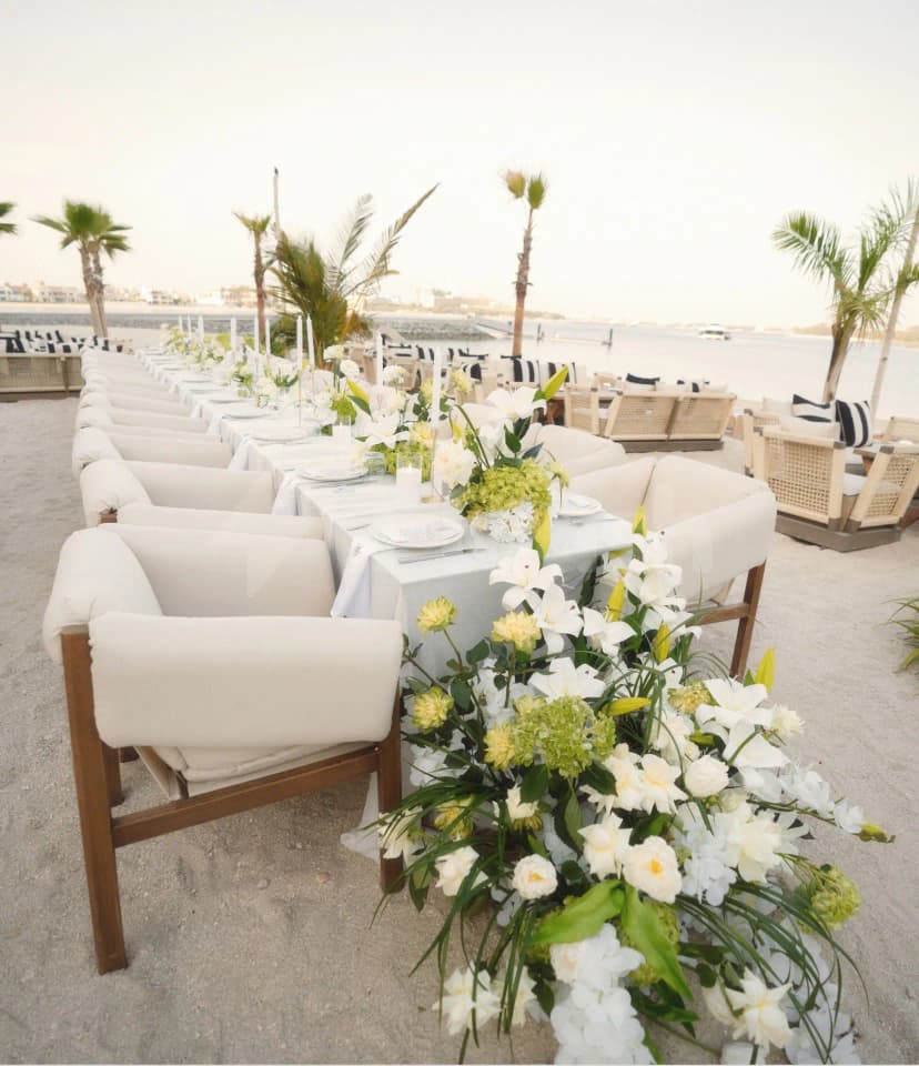 Terrace at Bebabel The Palm Restaurant in Dubai with sand floor and floral centrepieces