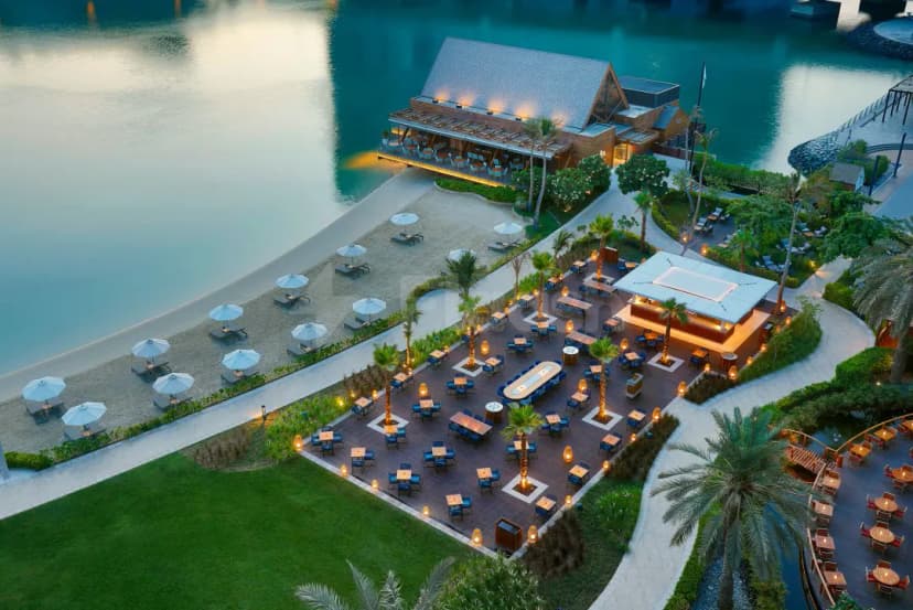Rooftop terrace at Brauhaus Restaurant Abu Dhabi with wooden deck and palm trees
