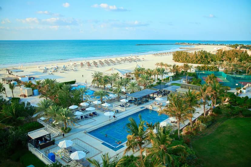 Rooftop terrace at Al Hamra Residence in Ras Al-Khaimah with blue swimming pool and palm trees