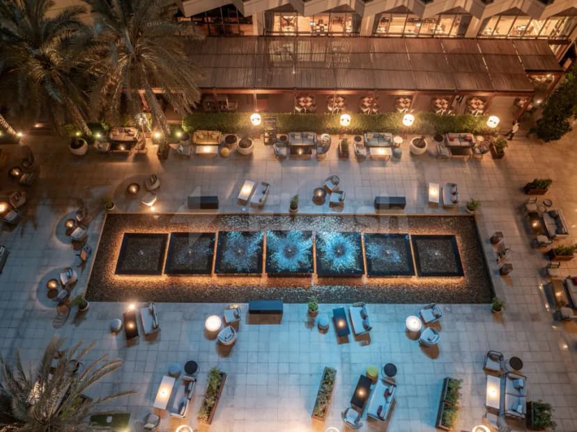 Rooftop terrace at Brauhaus Restaurant Abu Dhabi featuring a rectangular illuminated water feature and modern lounge seating under