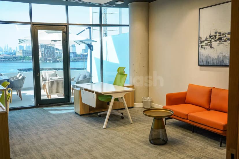 Meeting room at The Place Dubai Chambers in Dubai with large glass windows overlooking water and city skyline