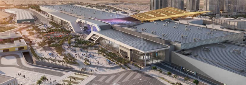 Modern entrance hall of Dubai Exhibition Centre in Dubai featuring a large glass facade and distinctive golden canopy