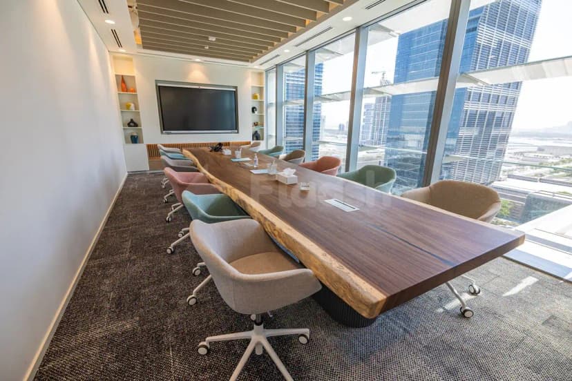 Boardroom at Cloud Spaces ADGM in Abu Dhabi featuring a live edge wooden conference table and floor-to-ceiling
