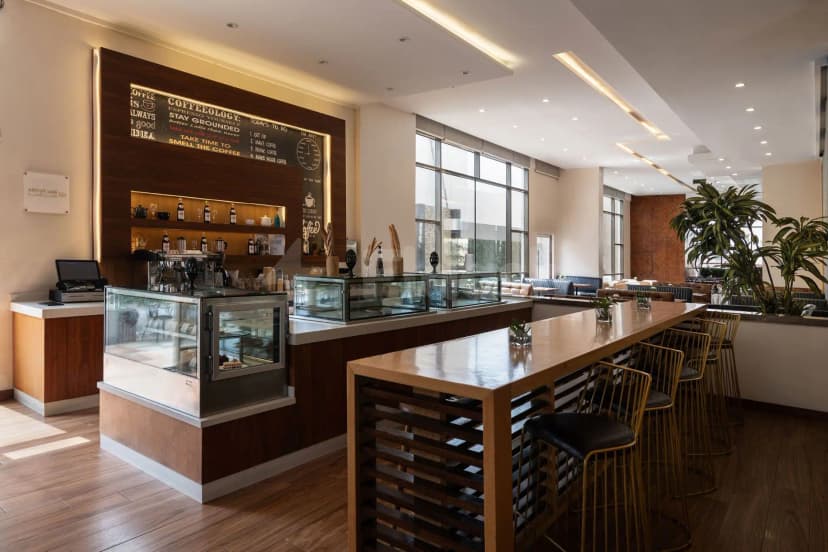 Bar counter at Warwick Hotel Jeddah in Jeddah with wooden panel and chalkboard menu