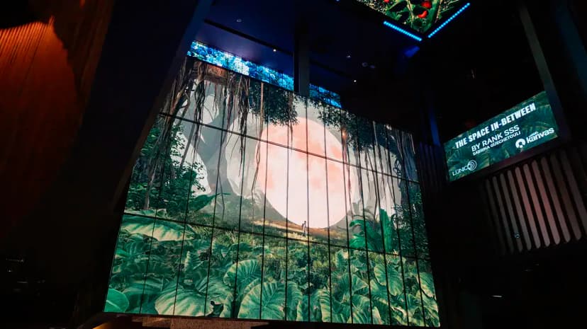 Entrance Hall at Kanvas Dubai featuring a large digital screen displaying a jungle mural with a full moon