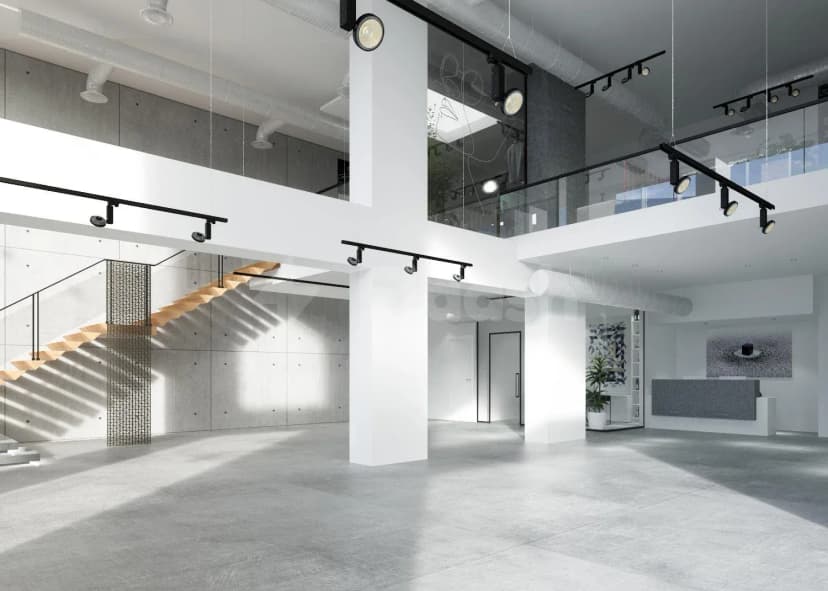 Double-height entrance hall at Lakum Artspace Riyadh Umm Al Hamam Al Gharbi with wooden staircase and concrete wall