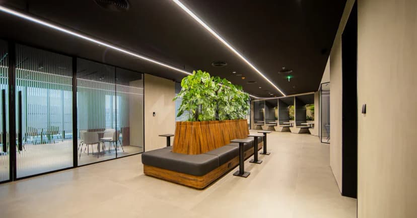 Long wooden planter with green plants in entrance hall at AXD Space Membership Club in Dubai