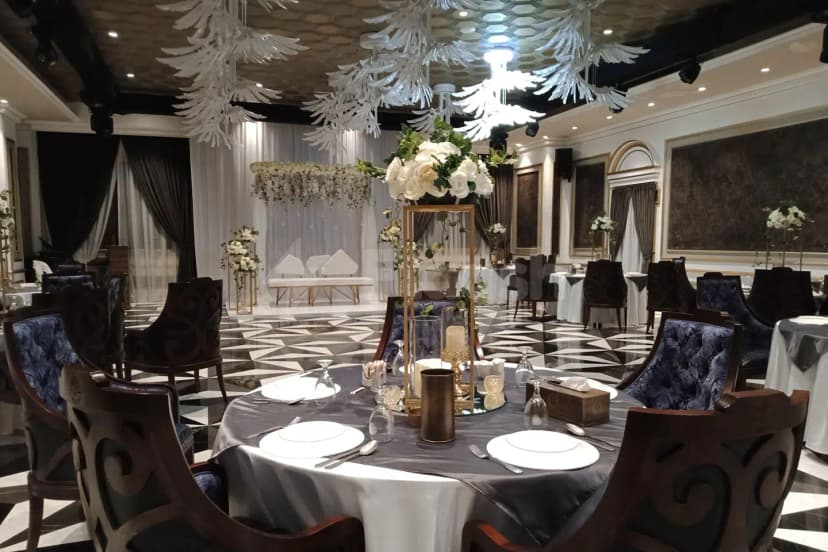 Ballroom at Al Meshwar Restaurant Dubai with white feather chandeliers and geometric black-and-white flooring