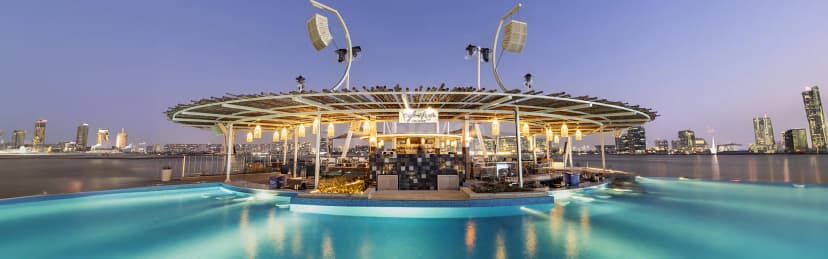 Rooftop terrace at Cafe del Mar Beach Club in Abu Dhabi with illuminated infinity pool