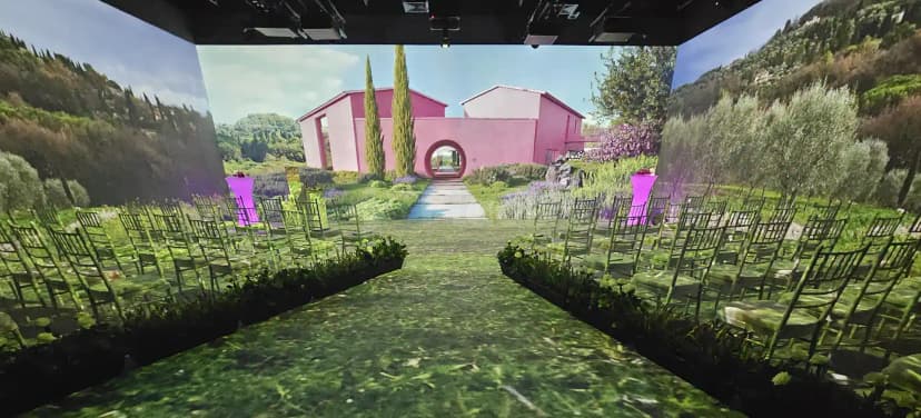 Meeting room at Kanvas Dubai with immersive garden projection backdrop featuring a pink building and circular archway