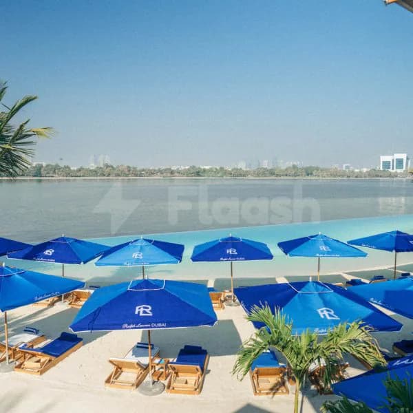 Rooftop terrace at Twiggy Dubai in Dubai with infinity pool edge overlooking calm water