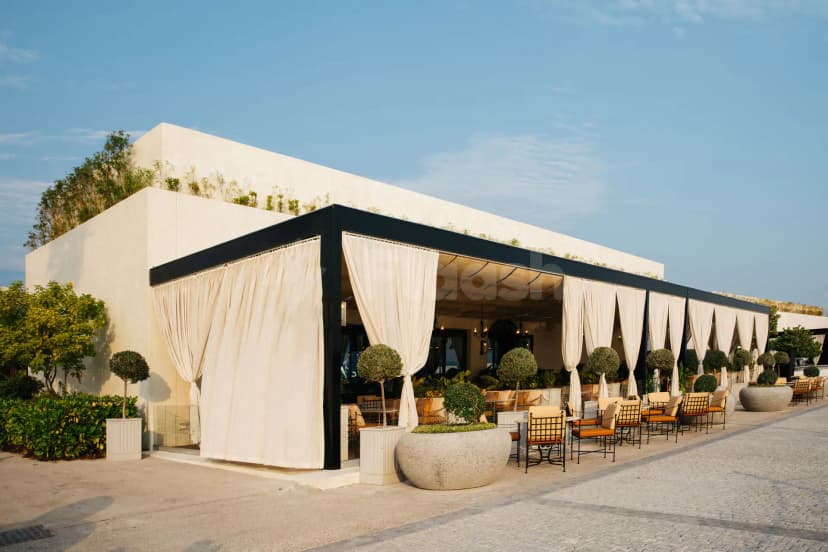 Rooftop terrace at Berenjak Acurio Restaurant Dubai featuring a black metal frame structure with cream sheer curtains