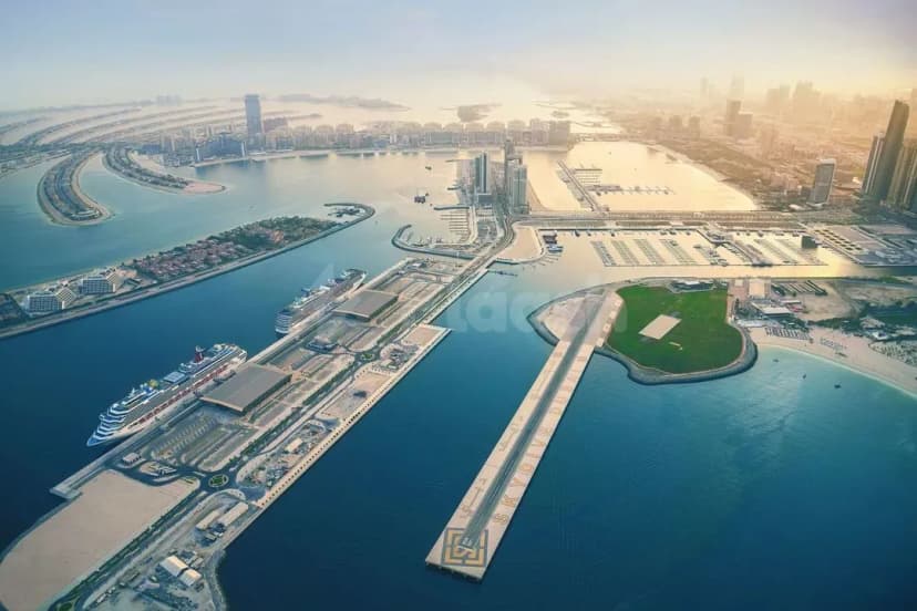 Facade at Dubai Harbour Cruise Terminal in Dubai with a concrete pier extending into the marina