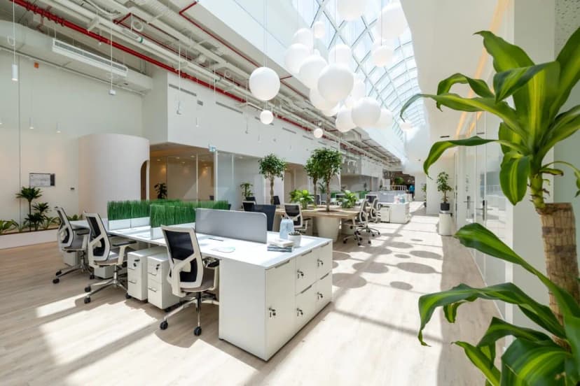 Open-plan office at Cloud Spaces Circle Mall Dubai featuring hanging white spherical lights and an arched skylight