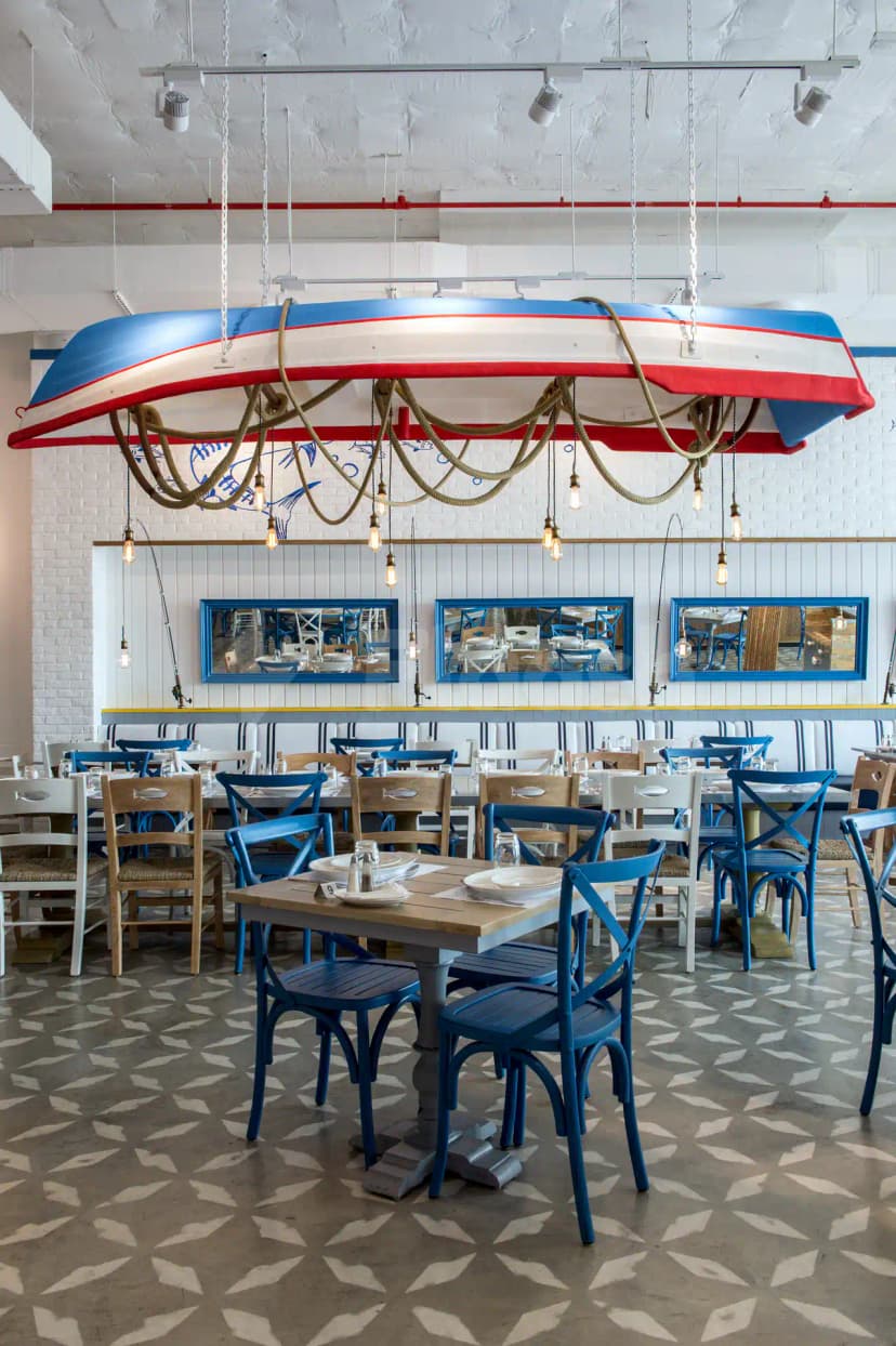 Inverted boat ceiling fixture with rope lighting at Ibn AlBahr Seafood Restaurant in Dubai, featuring white brick walls
