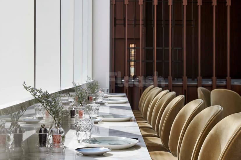 Long marble table meeting room at Form Hotel Dubai in Dubai with vertical wooden slat partition