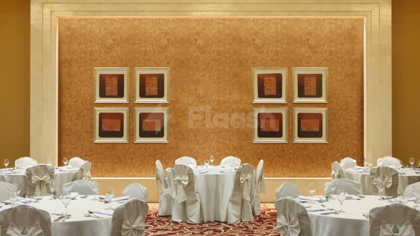 Ballroom at Le Meridien Towers in Makkah with gold textured wall and framed artwork