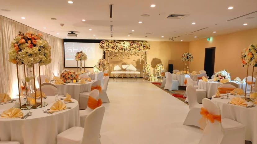 Ballroom at Vintage Grand Hotel in Dubai with hanging floral arch over stage