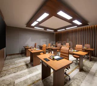 Boardroom at Swissotel Living Jeddah featuring wooden desks, leather chairs, and a recessed ceiling with integrated lighting