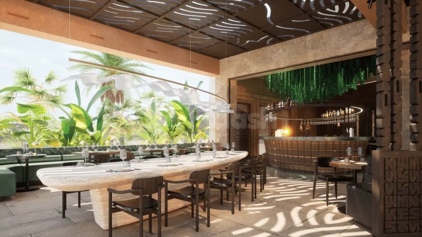 Long stone table with dark wooden chairs in Kaimana Restaurant and Beach, Dubai, featuring a green plant wall