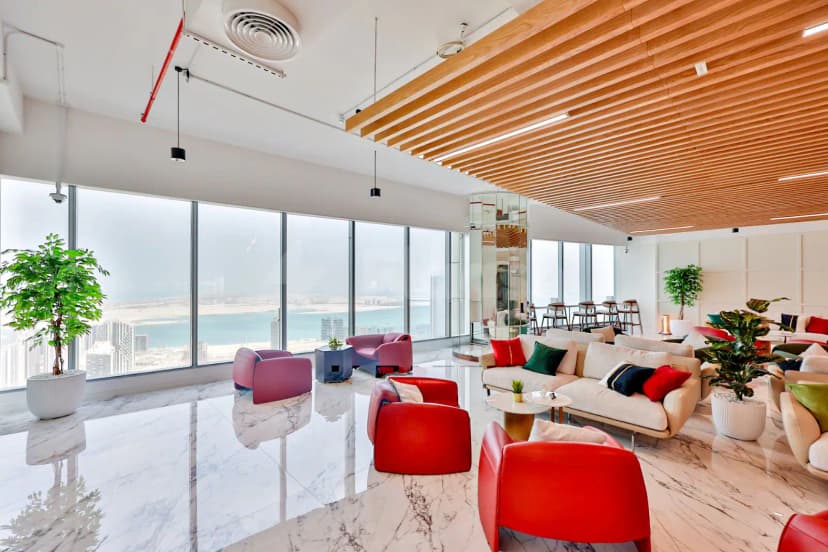 Entrance hall at The Place Dubai Chambers in Dubai featuring a marble floor and large windows with sea