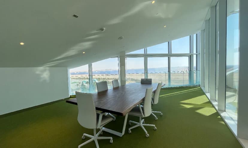 Boardroom at Sustainability & Innovation Centre Dubai featuring floor-to-ceiling windows with sea and airport runway views
