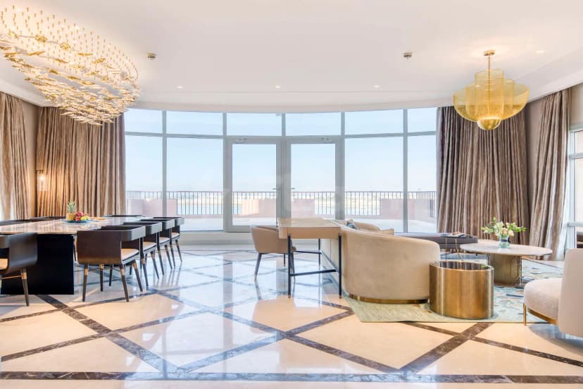 Ballroom at Kempinski Sariya in Yanbu featuring a large curved window with glass doors and a fish-shaped chandelier