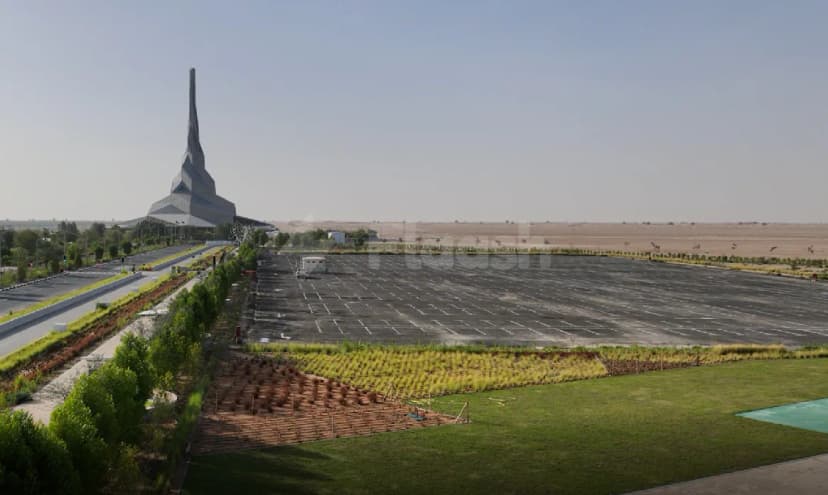 Large paved parking lot at Sustainability & Innovation Centre Dubai with young trees in rows