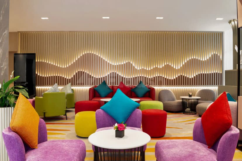 Modern meeting room at La Quinta by Wyndham Abu Dhabi Al Wahda with backlit wave-patterned wooden slat wall