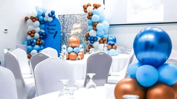 Ballroom at Al Ain Palace Hotel in Abu Dhabi featuring blue and copper balloon arches and a sequin