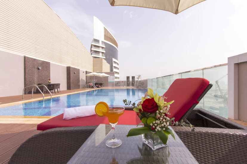Rooftop terrace at Treppan Hotel & Suites in Dubai with a blue swimming pool
