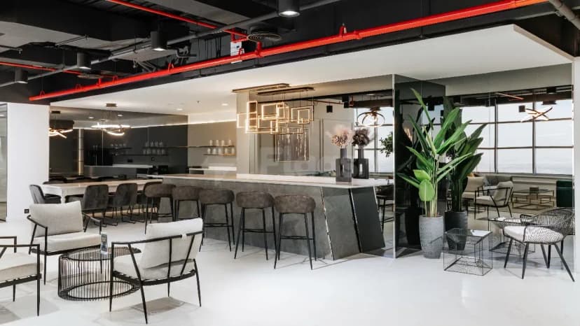 Restaurant at The Place Dubai Chambers featuring a grey marble bar counter and geometric pendant lights under