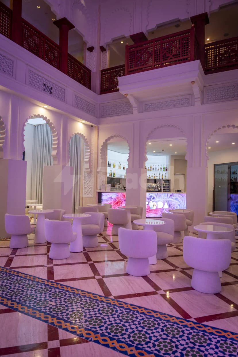 Restaurant at TODA - Theatre Of Digital Art in Dubai with white arched doorways and red wooden lattice railings