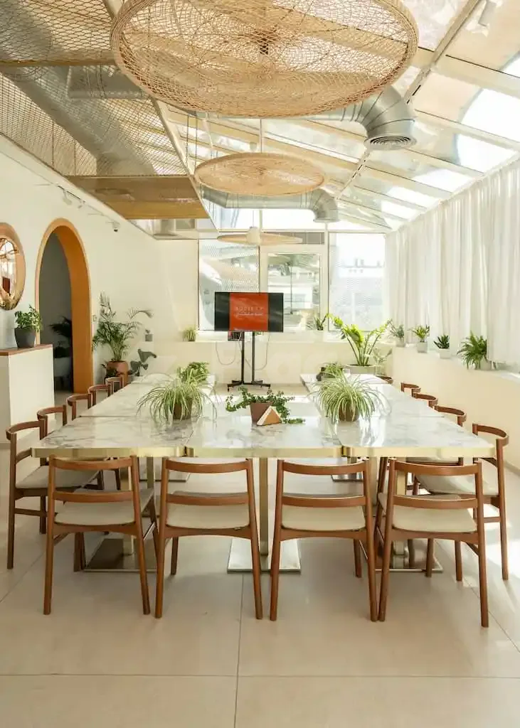 Meeting room at Society Restaurant Abu Dhabi with large woven pendant lights and glass ceiling