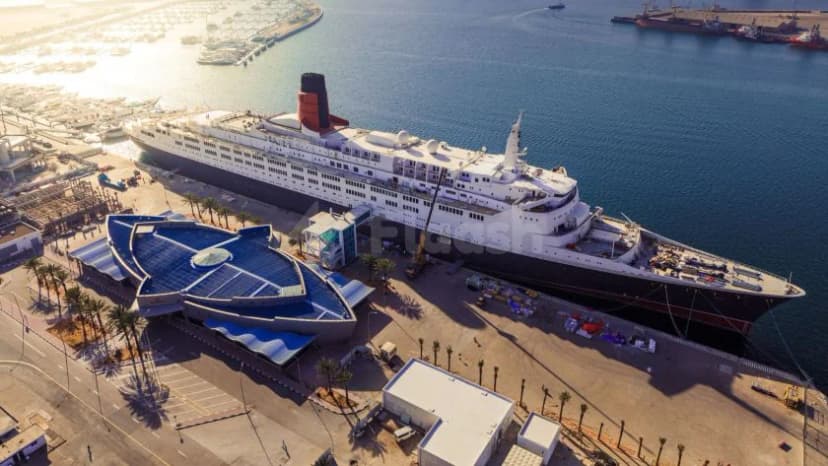 Facade of Theatre by QE2 in Dubai with the historic QE2 cruise ship docked alongside