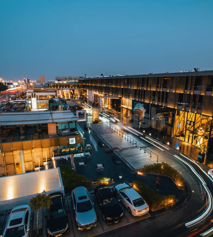 Rooftop terrace at Jareed Hotel Riyadh featuring outdoor seating, glass railings, and warm ambient lighting against an evening