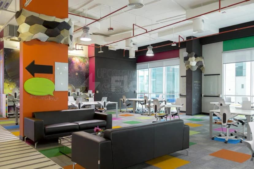 Open-plan meeting room at Dubai Silicon Oasis Authority in Dubai with orange pillar and chalkboard wall