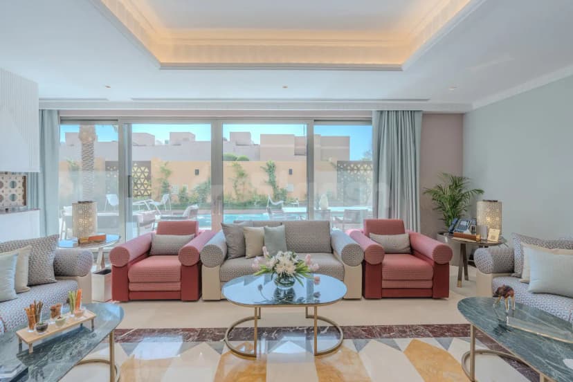 Lounge area at Vivienda Hada Residences in Riyadh with geometric tile floor and pool view