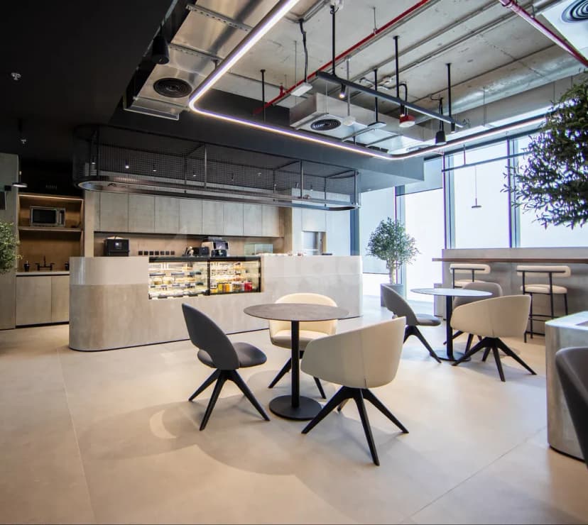 Modern restaurant at AXD Space Membership Club in Dubai with exposed ceiling ductwork