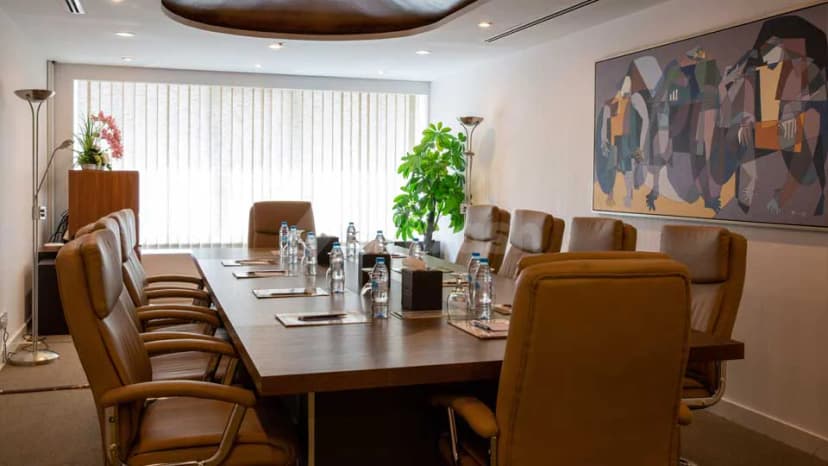 Boardroom at Grand Central Hotel in Dubai with large abstract painting on wall