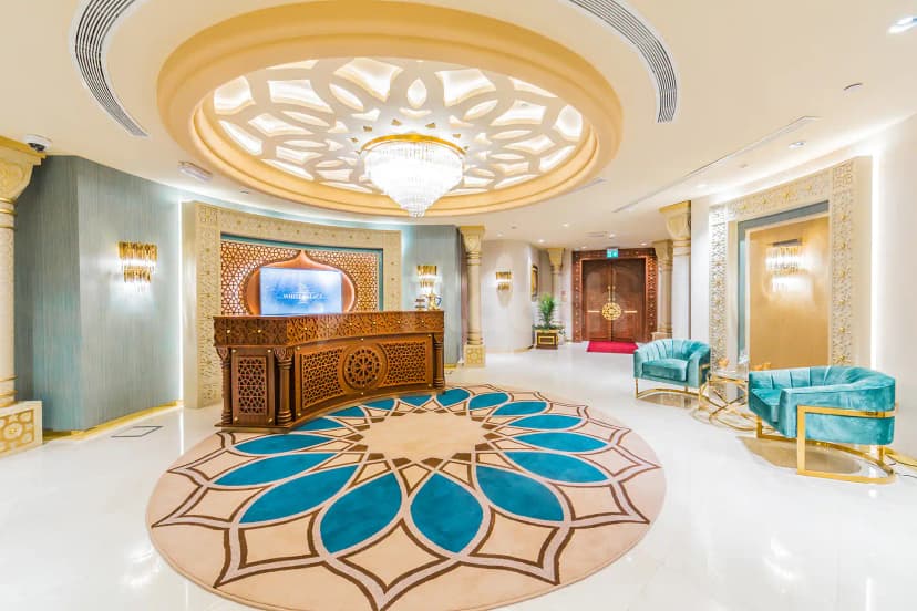 Entrance hall at White Palace Wedding Hall in Doha with ornate wooden reception desk