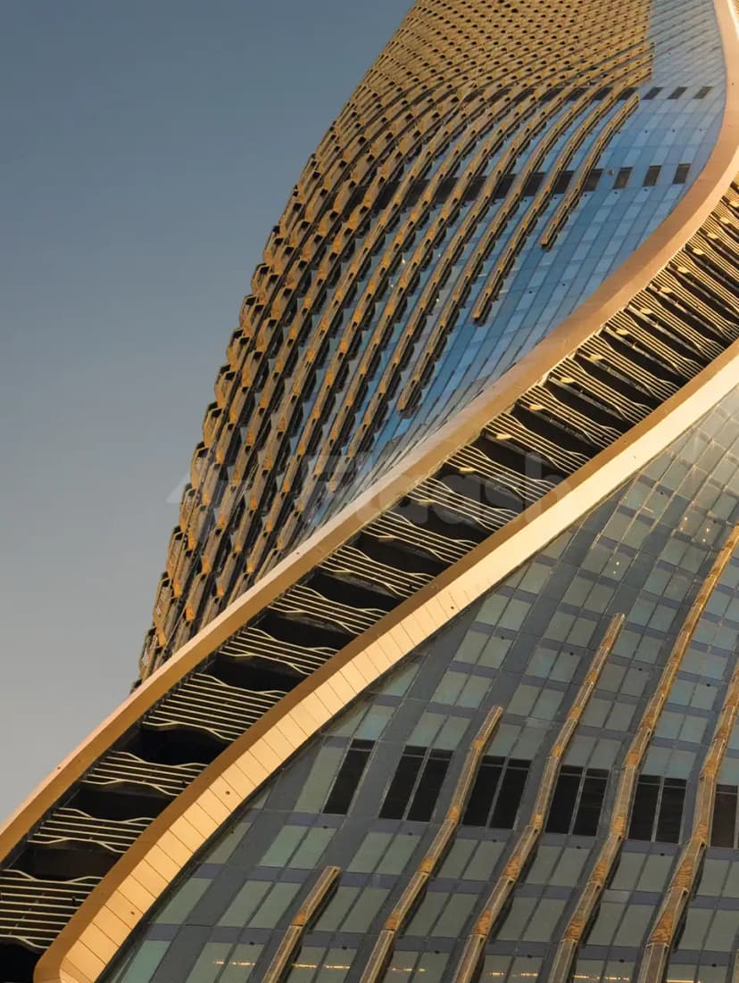 Curved glass facade at Mandarin Oriental Downtown Dubai in Dubai with gold-toned metal cladding