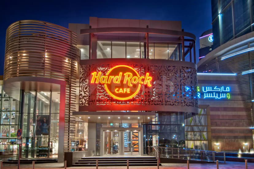 Hard Rock Cafe Dubai facade at night featuring its illuminated neon sign and ornate metal screen