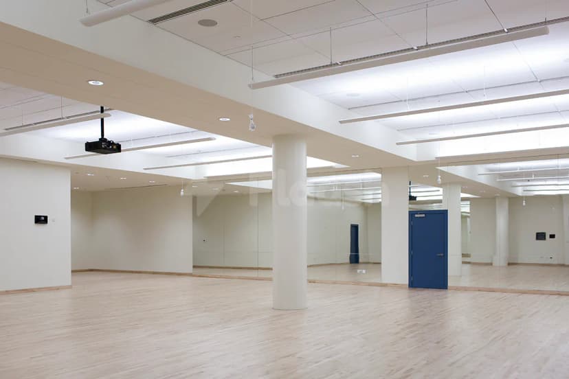 Meeting room at NYU Abu Dhabi Athletic Field in Abu Dhabi featuring light wooden flooring, full-length wall mirrors