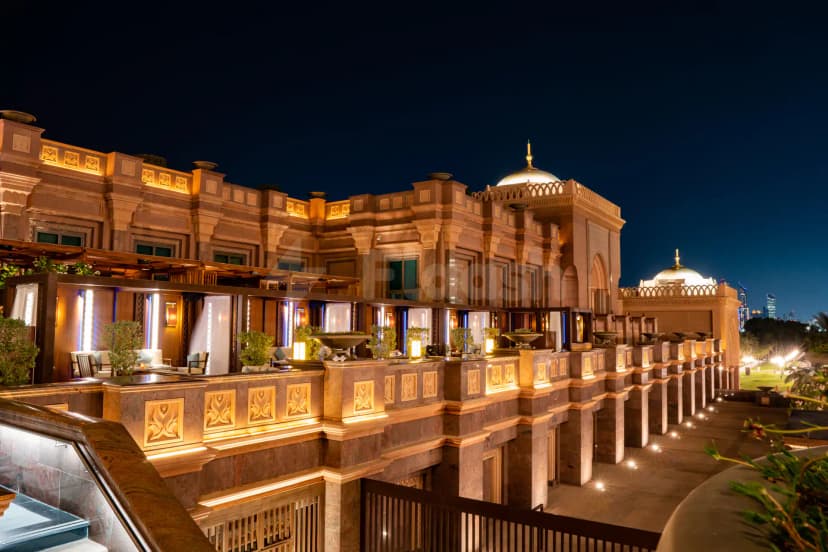 Rooftop terrace at Hakkasan Abu Dhabi featuring illuminated stone architecture with ornate carvings and a domed roof under