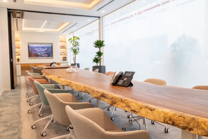 Boardroom at Cloud Spaces Circle Mall Dubai featuring a live edge wooden table and beige rolling chairs