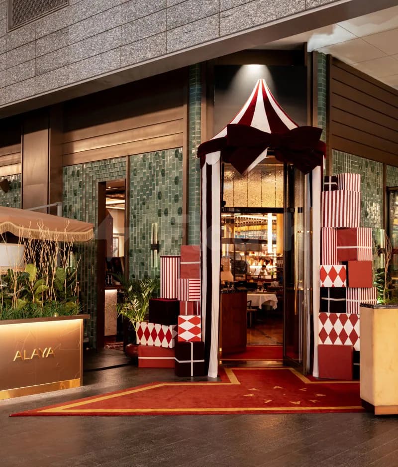 Entrance hall at Alaya Dubai in Dubai with red carpet and striped canopy