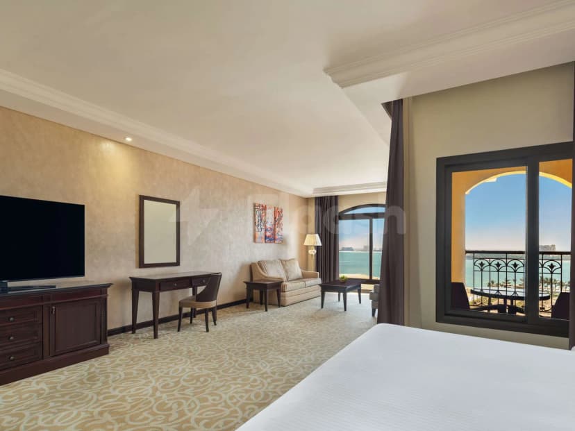 Bedroom at Al Liwan Restaurant Ras Al Khaimah with arched window overlooking the sea