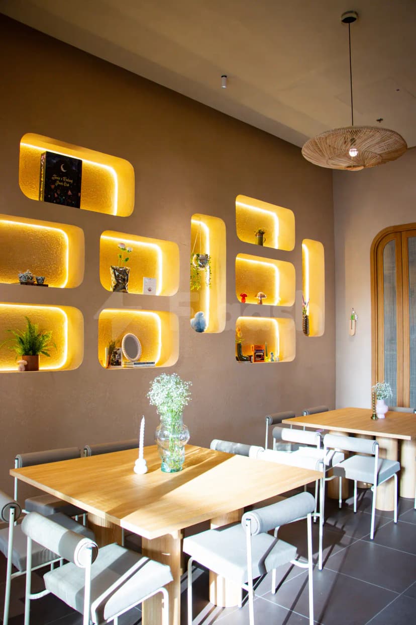 Recessed illuminated shelves at Tania's Teahouse Dubai Hills in Dubai, with warm ambient lighting