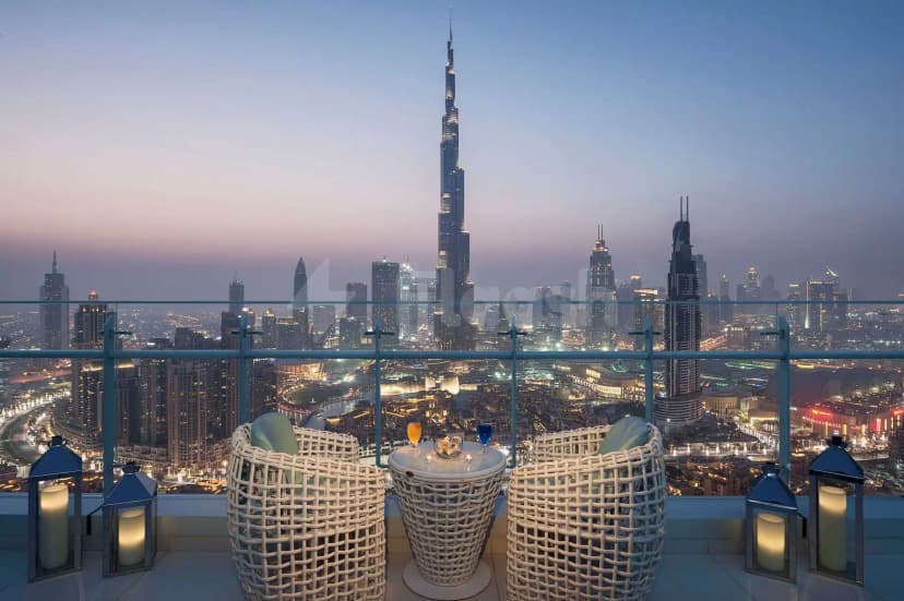 Rooftop terrace at Blooms Ava Restaurant in Dubai with white wicker seating, glass railing, and Burj Khalifa skyline